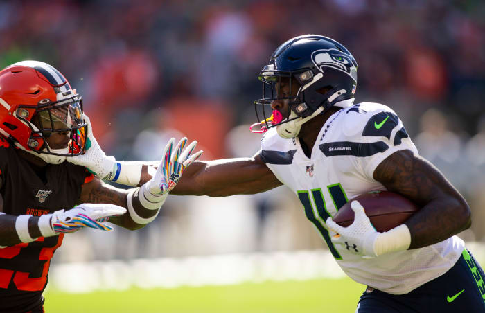 Seattle Seahawks wide receiver D.K. Metcalf (14) stiff arms Cleveland Browns strong safety Damarious Randall (23) during the first quarter at FirstEnergy Stadium.